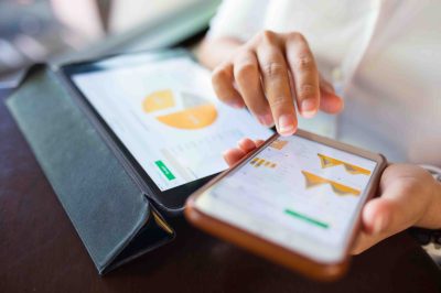 Businesswoman check data in smartphone and tablet Businesswoman check data in smartphone and tablet